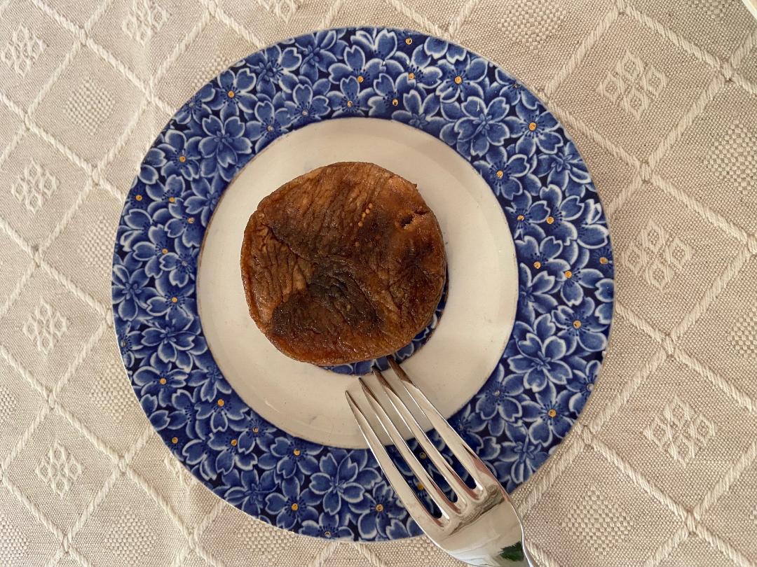 A Fico Girotti placed on a blue-decorated ceramic plate, with a fork beside it.