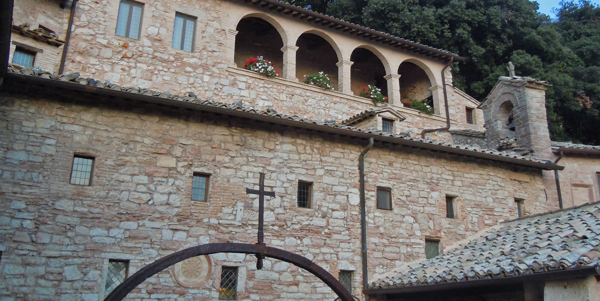 Eremo delle Carceri: an ancient stone sanctuary on Mount Subasio, surrounded by greenery and Franciscan spirituality.
