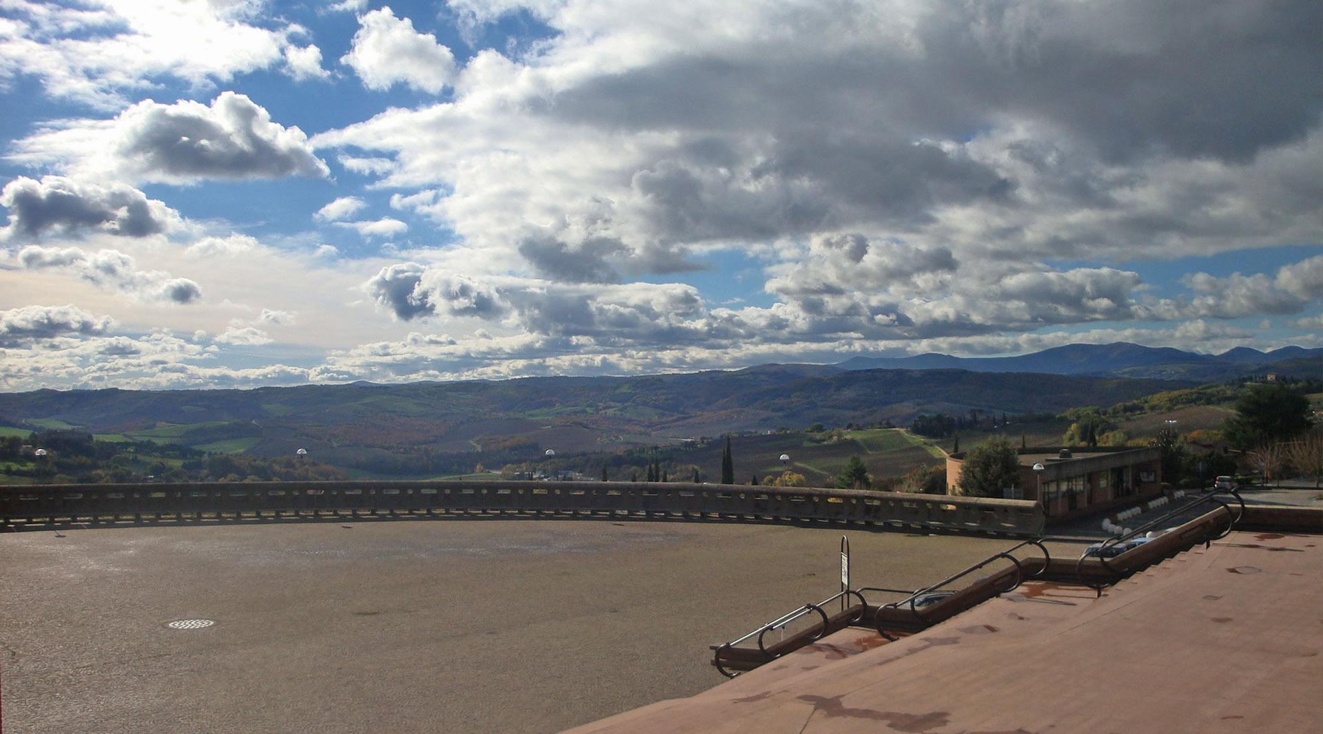 Panoramic view from the forecourt of the Sanctuary of Merciful Love, with a cloudy sky and diffused light.