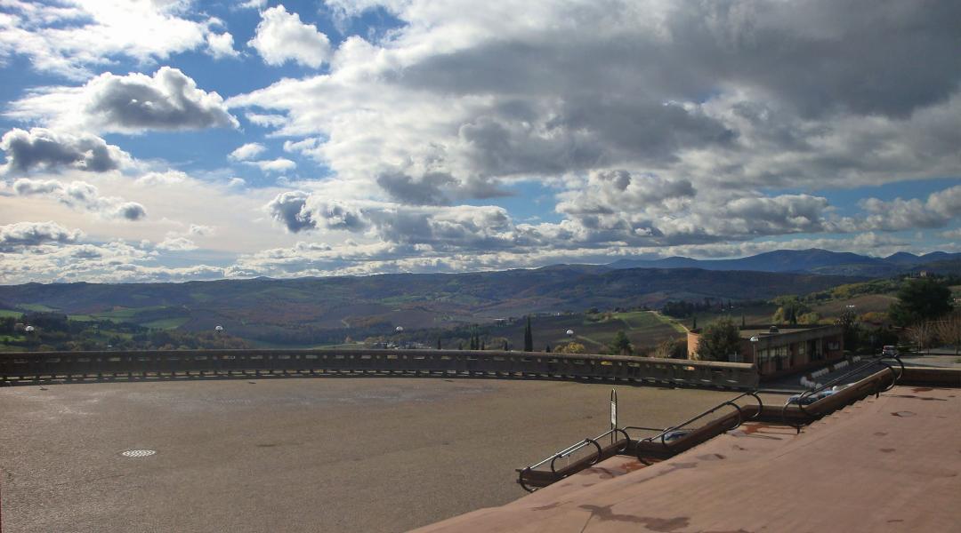 Panoramic view from the forecourt of the Sanctuary of Merciful Love, with a cloudy sky and diffused light.