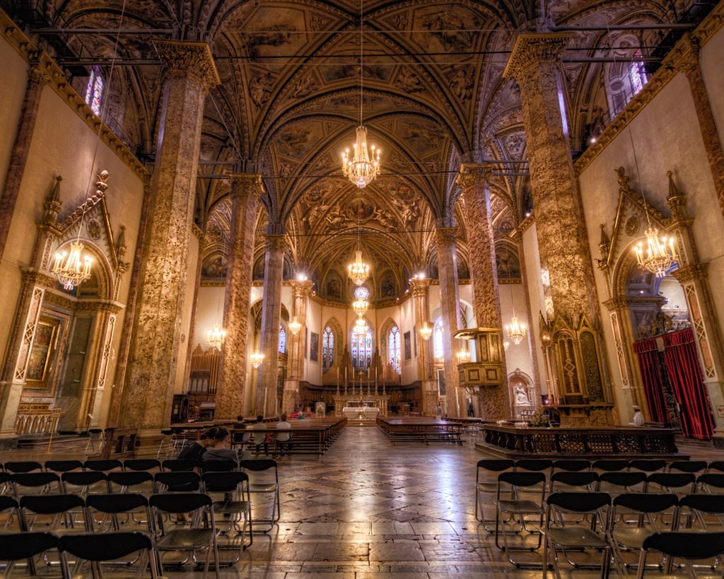 Panoramic view of San Lorenzo Cathedral’s interior, with its tall nave, grand columns, and the high altar in the background.