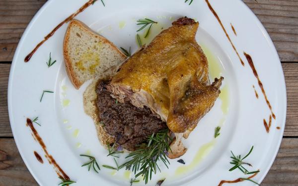  Roast guinea fowl on toasted bread with chicken liver sauce, garnished with rosemary, olive oil and balsamic glaze. 