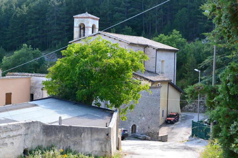 Immagine: Stone church of the Sanctuary of Cancelli with bell gable, surrounded by greenery on the edge of the village. 