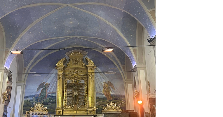 Vault decorated with a starry sky and angels, a golden Baroque altarpiece, and a scenic background with rays of light.