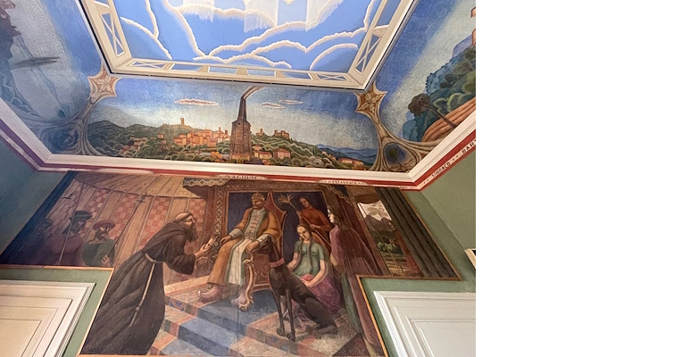 Pictorial cycle in a council hall with landscapes, historical scenes, and a painted sky with clouds.