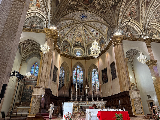 Interior of San Lorenzo Cathedral in Perugia with the high altar and frescoed vaults.