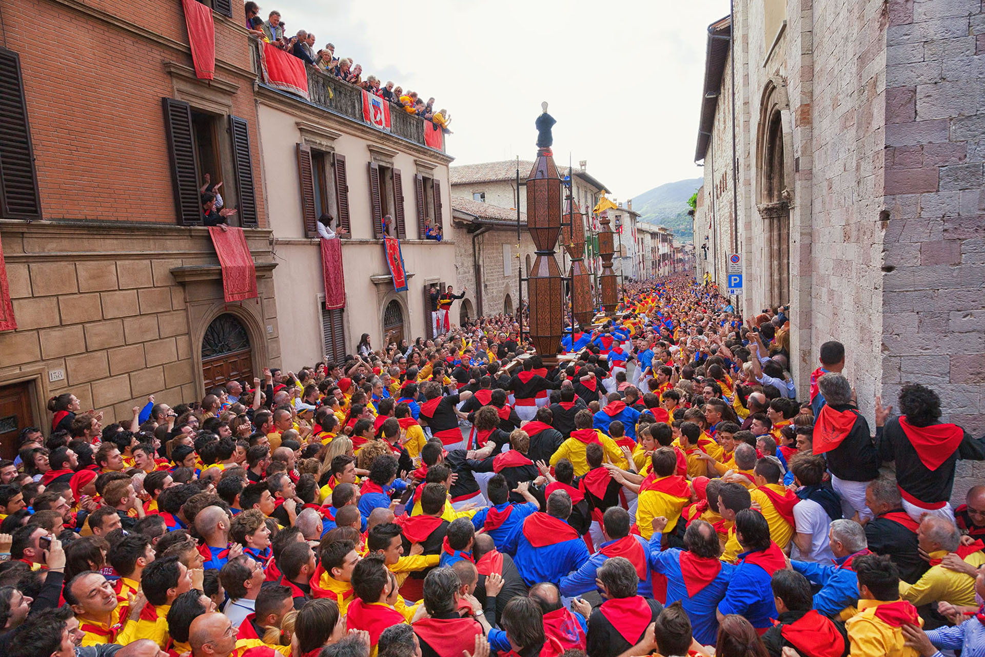 Festa dei Ceri in Gubbio: candles in the middle of a Gubbio street amidst the crowd