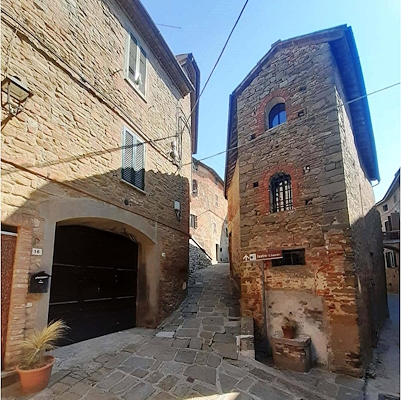 Narrow cobbled streets of Panicale, lined with stone buildings.