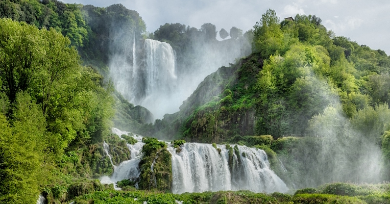 View of the Marmore Falls with two main drops amidst lush vegetation
