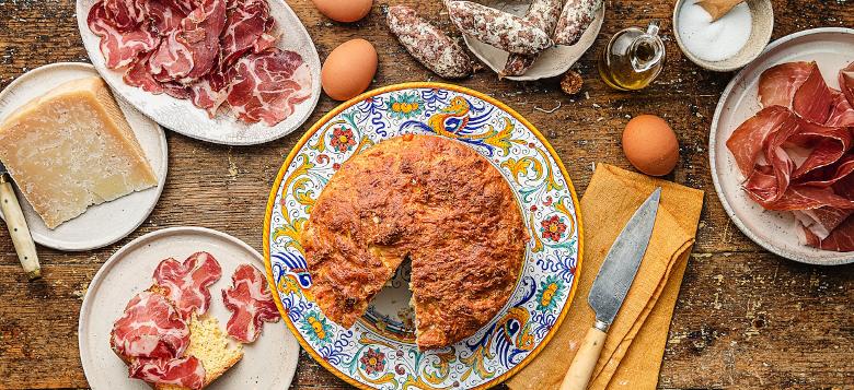 Immagine: Table with Easter cake on Deruta ceramic plate, capocollo, pecorino and other pork products 