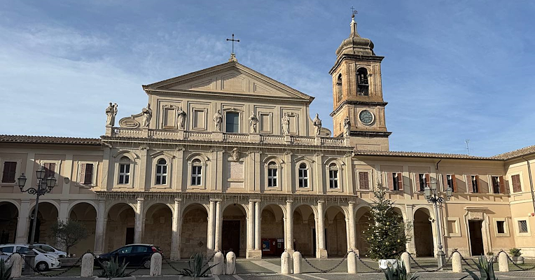  Vue frontale de la cathédrale de Santa Maria Assunta de Terni, avec un portique, des statues d’évêques sur la balustrade supérieure et le clocher à droite, et la place devant la cathédrale 