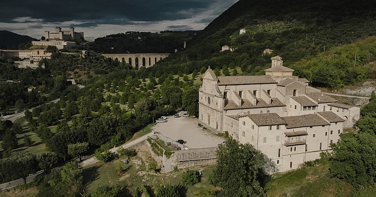 Aerial view of the Monastery of San Pietro in Spoleto, with the Rocca Albornoziana and the Ponte delle Torri in the background.