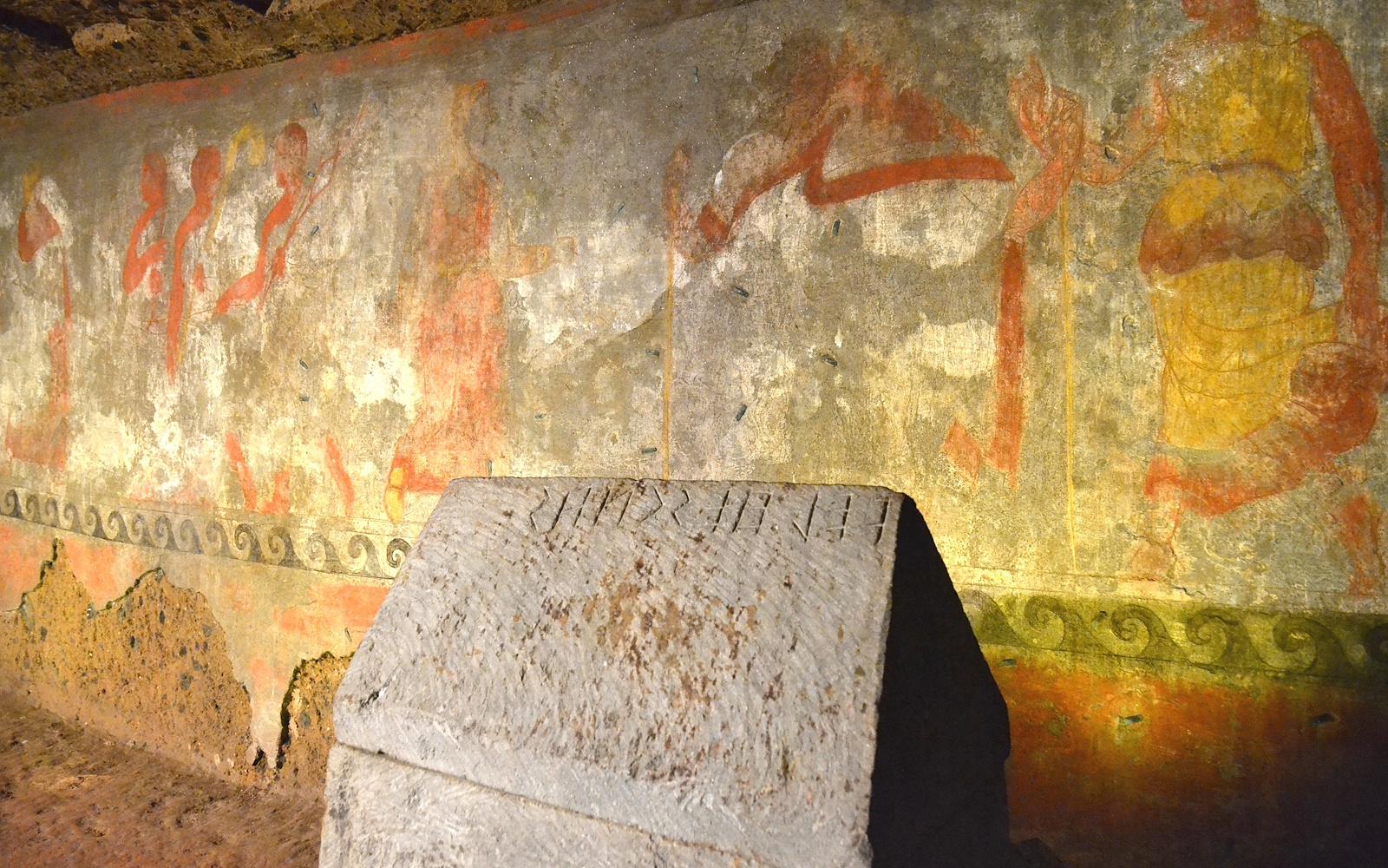 Urn with inscription placed in front of the polychrome wall painting of the Tomb of the Hescanas