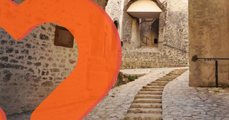  Stone streets and stairways with arches and ancient walls in the village of Usigni. 