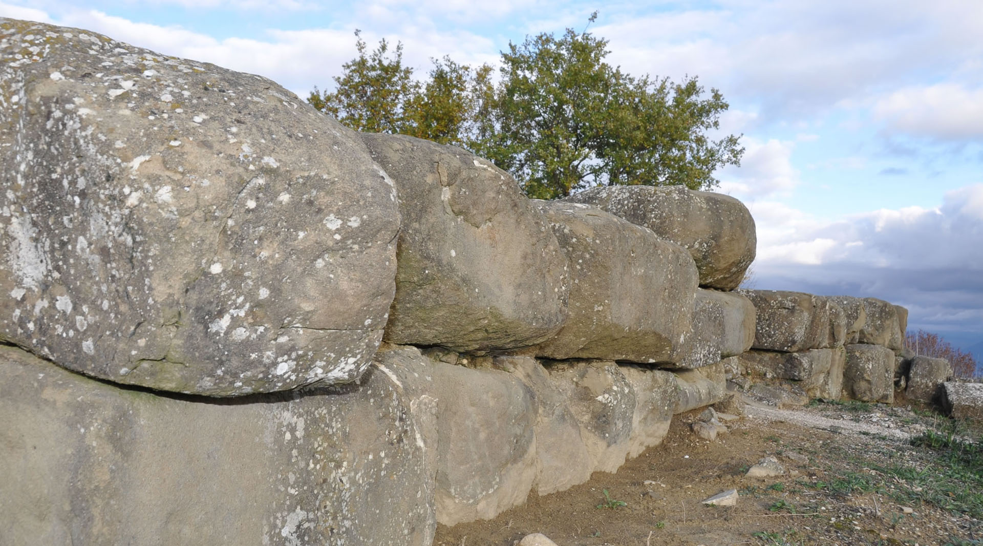 Stone walls made of large blocks from the ancient city of Urvinum Hortense along the edge of the archaeological site.