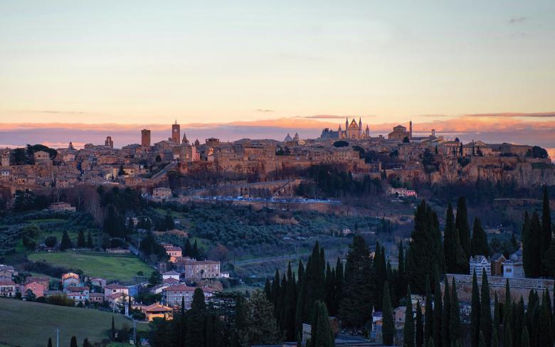 Immagine: Panoramic view of the city of Orvieto illuminated by the sunset light, resting on its tuff cliff. 