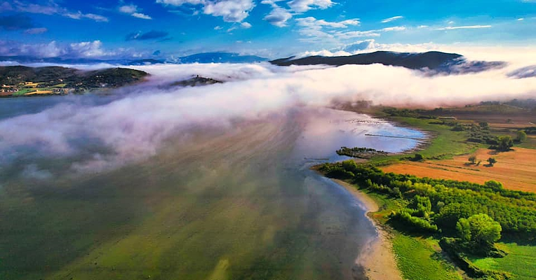 Mist moving over Lake Trasimeno, the Castle of San Savino appears like magic in the background.