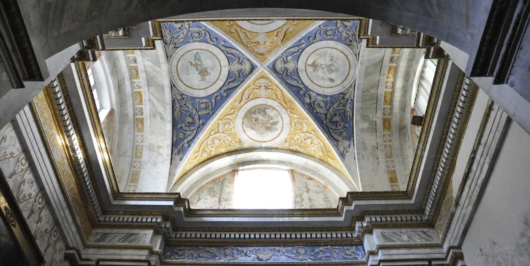Frescoed vault with golden and blue motifs in the Collegiata di Santa Maria Assunta e San Gregorio in Montone.