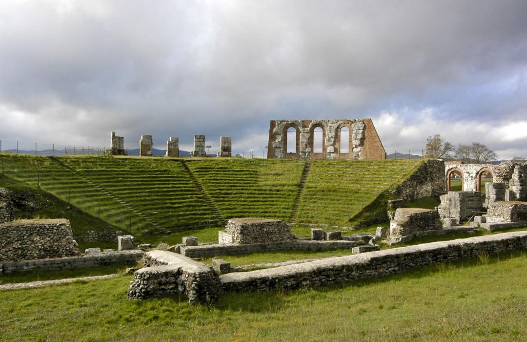 View from the orchestra of the interior of the Roman theatre of Gubbio with the cavea covered by the steps and, at the back, part of the upper archway