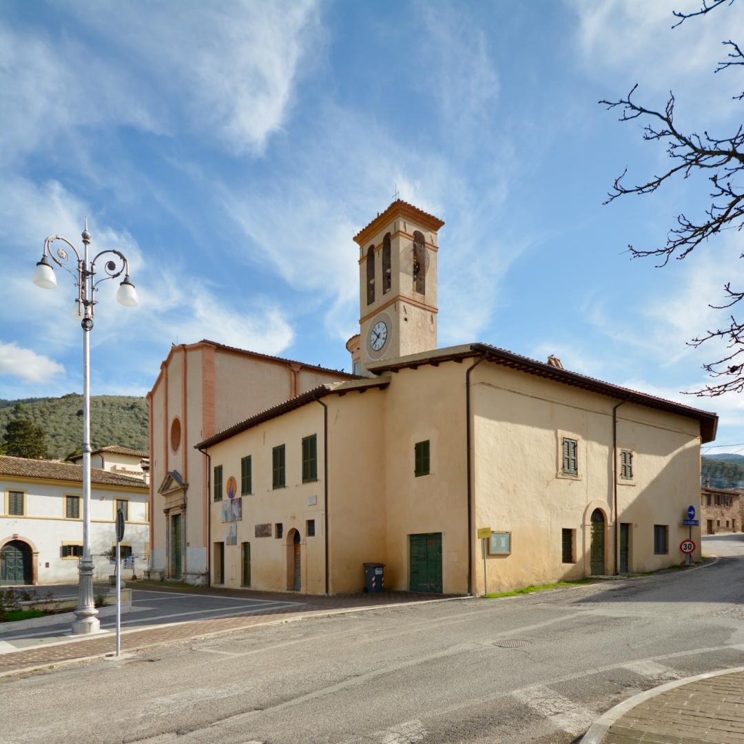Façade of the Church of Madonna della Bianca with bell tower and clock in a quiet square