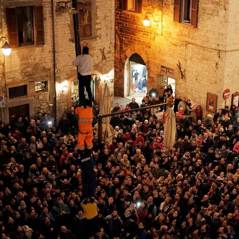 Piazza Giordano Bruno in Gubbio packed with people at the Feast of St Martin - Gubbio